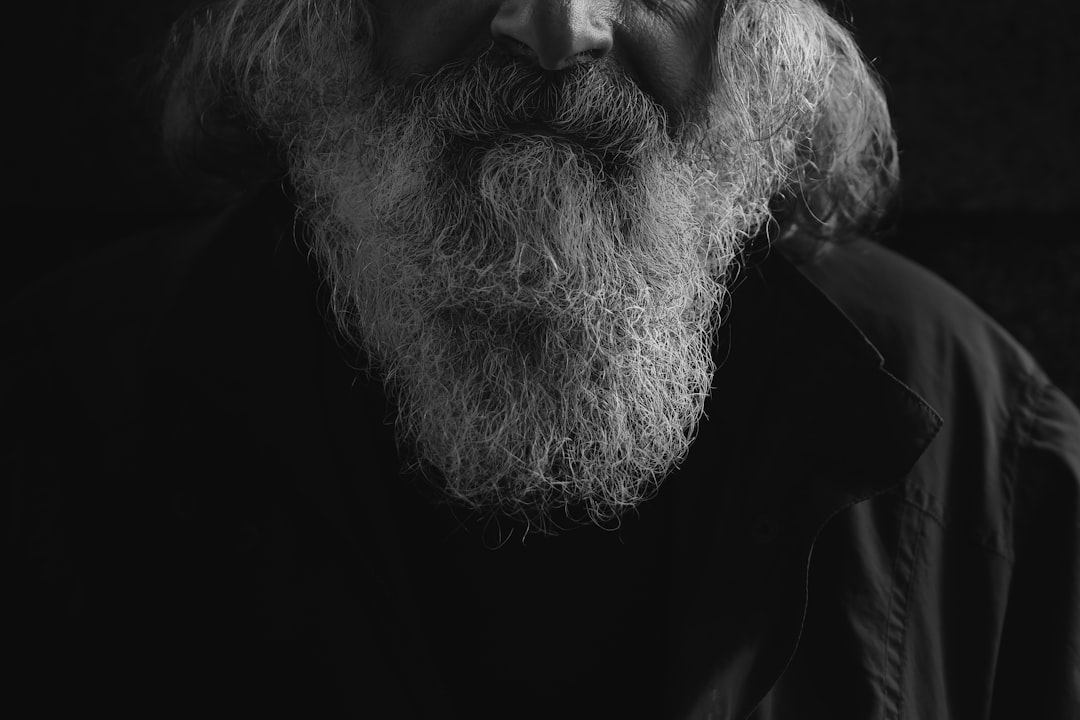 man's beard grayscale photo