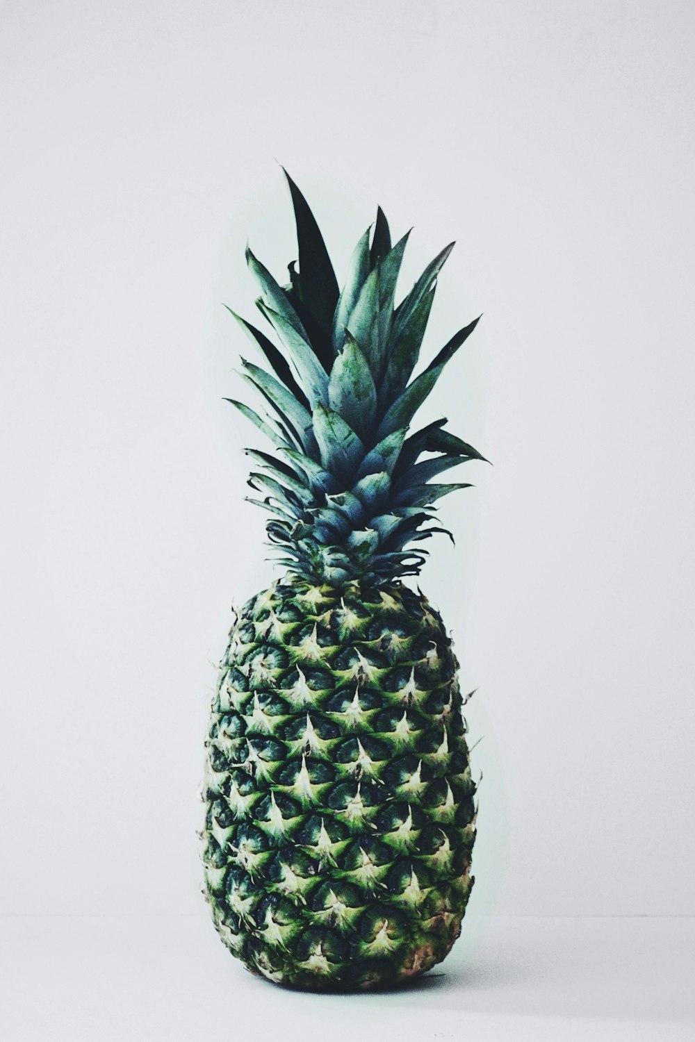 green pineapple on white background