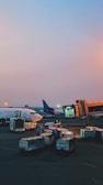 An airport scene with cargo planes being loaded with freight.