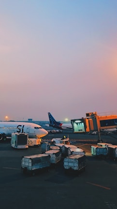 An airport scene with cargo planes being loaded with freight.