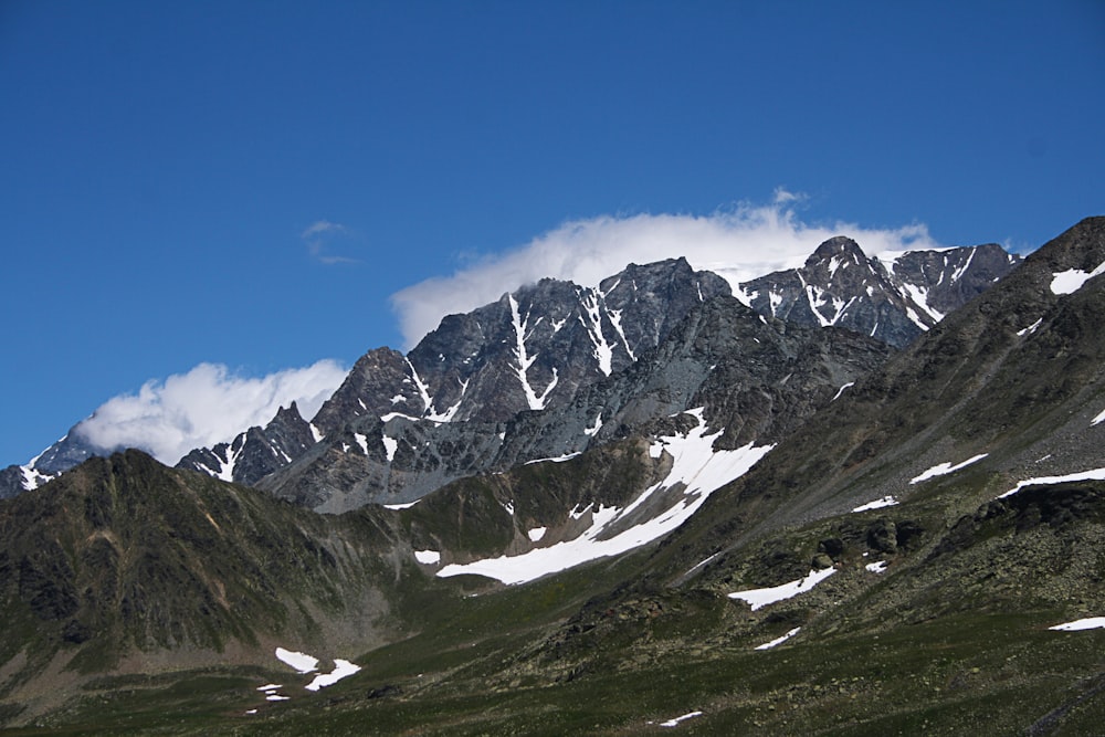 rocky and snow covered mountain during day