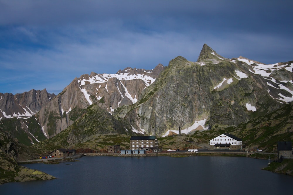 snow-covered mountain near body of water under blue sky