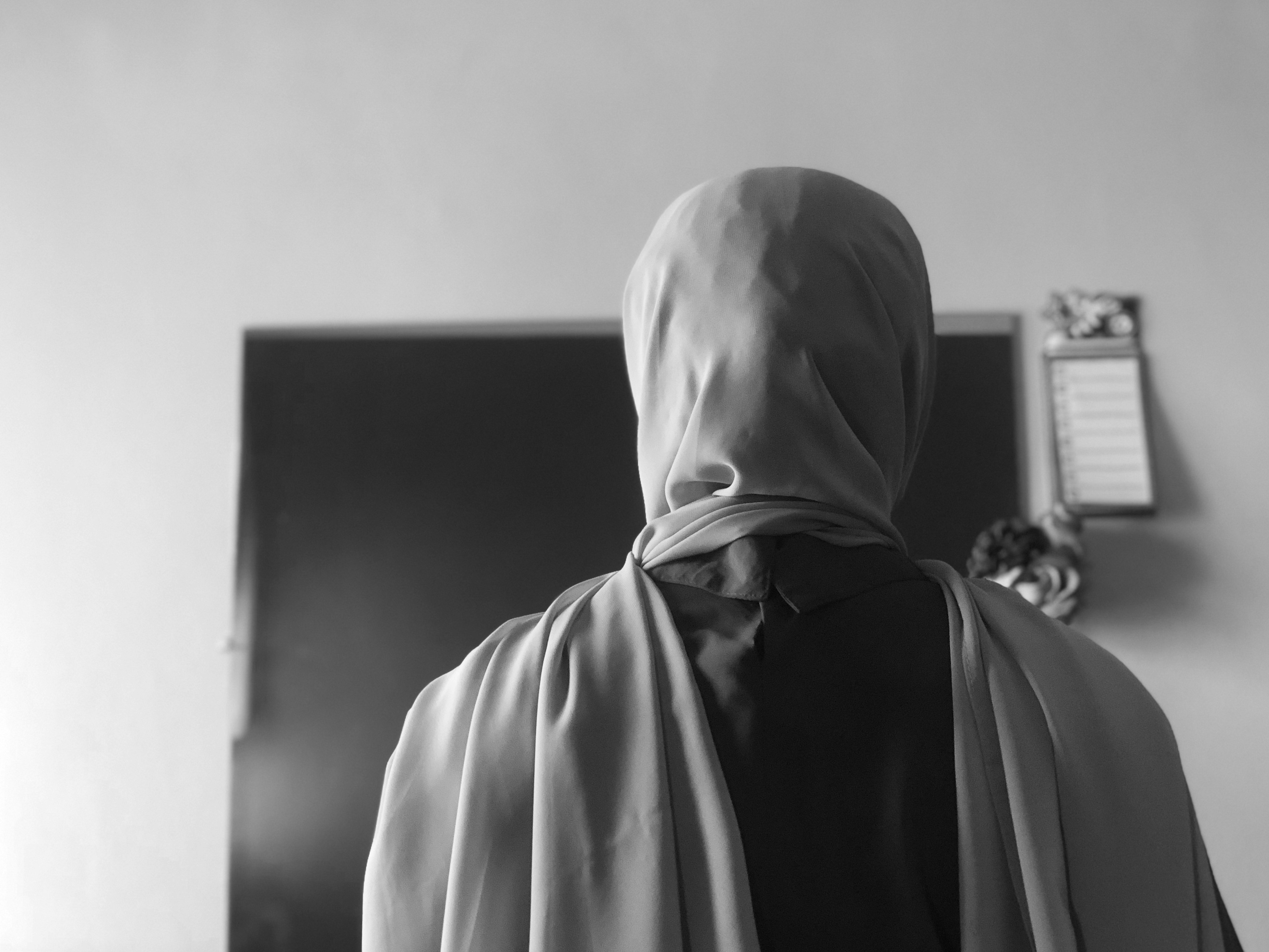 grayscale photo of a person on a hijab