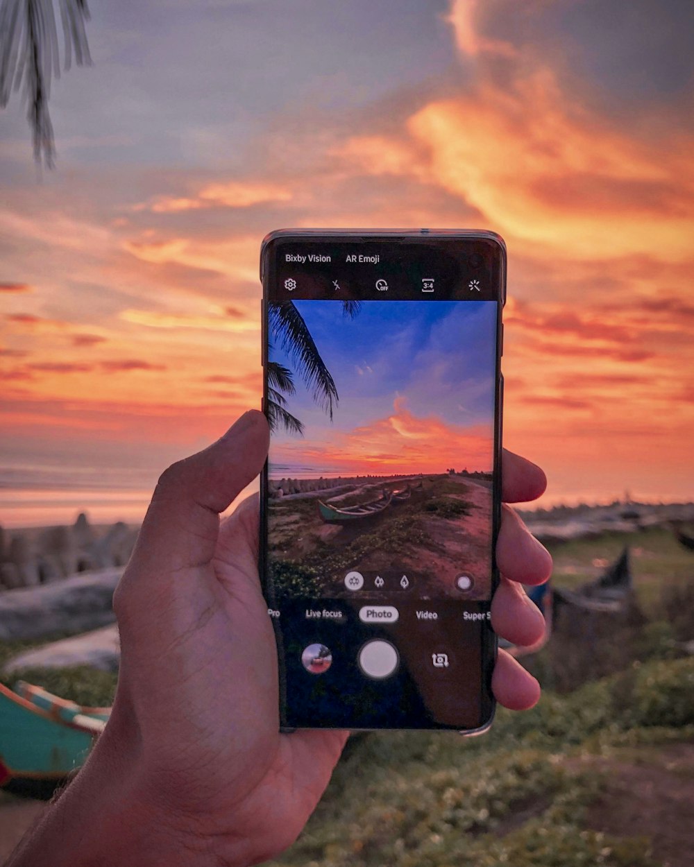 person capturing sunset