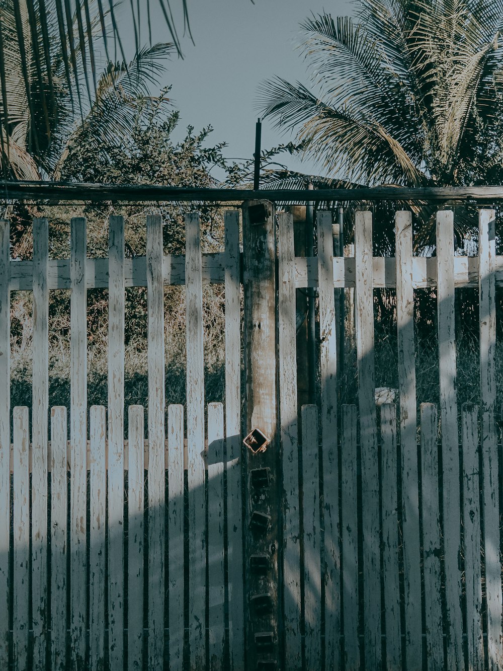 gray and black wooden gate close-up photography