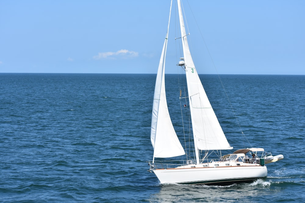 white yacht in body of water during daytime