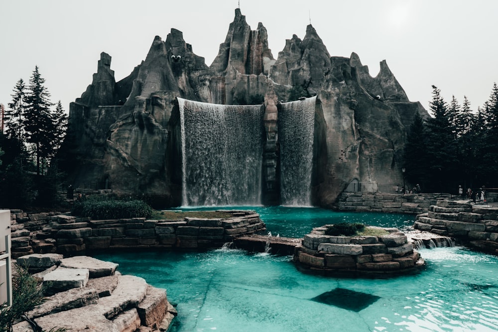 waterfalls under white sky at daytime