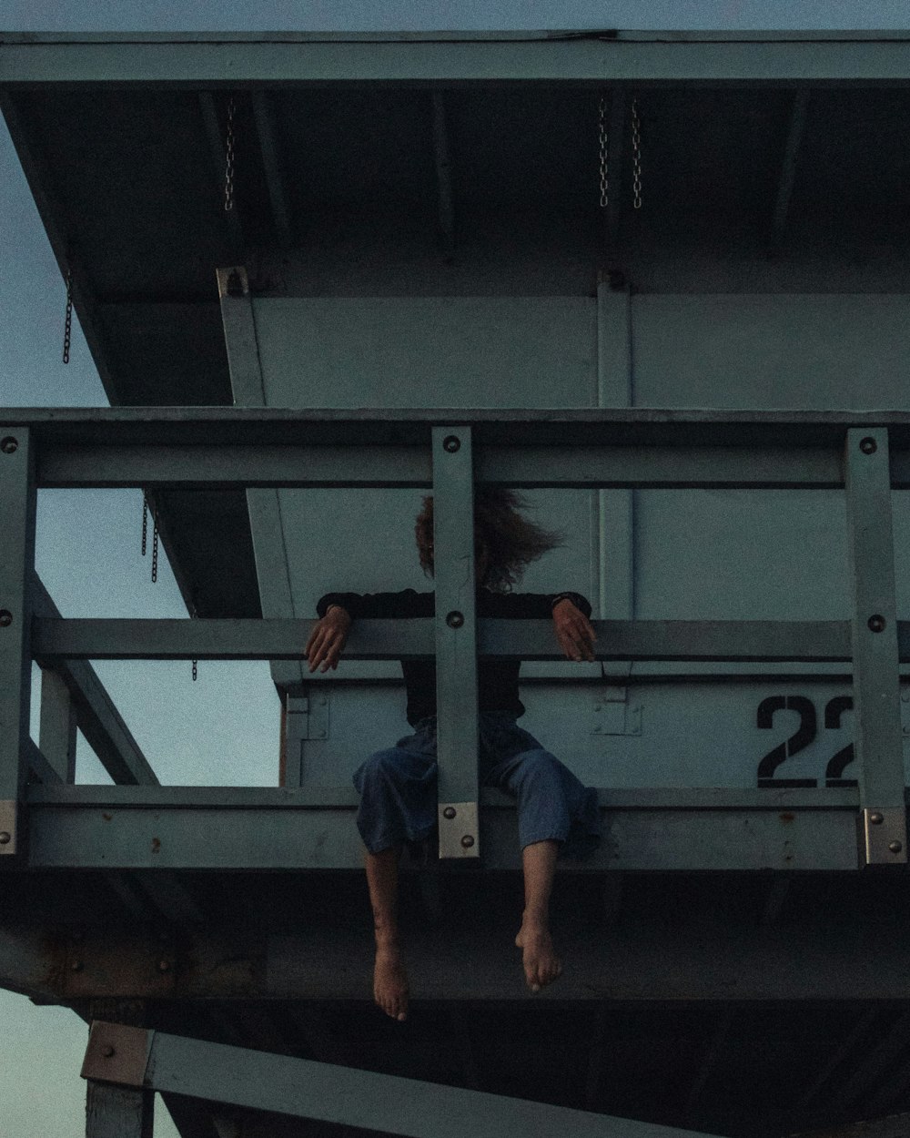 woman sitting and leaning on lifeguard