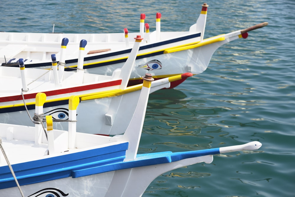 closeup photo of three white boats