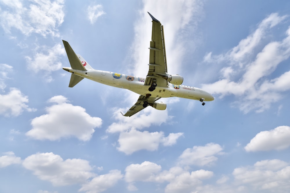 white airliner flying on sky