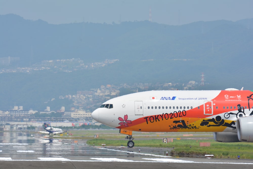 Tokyo 2020 plane on runway during daytime
