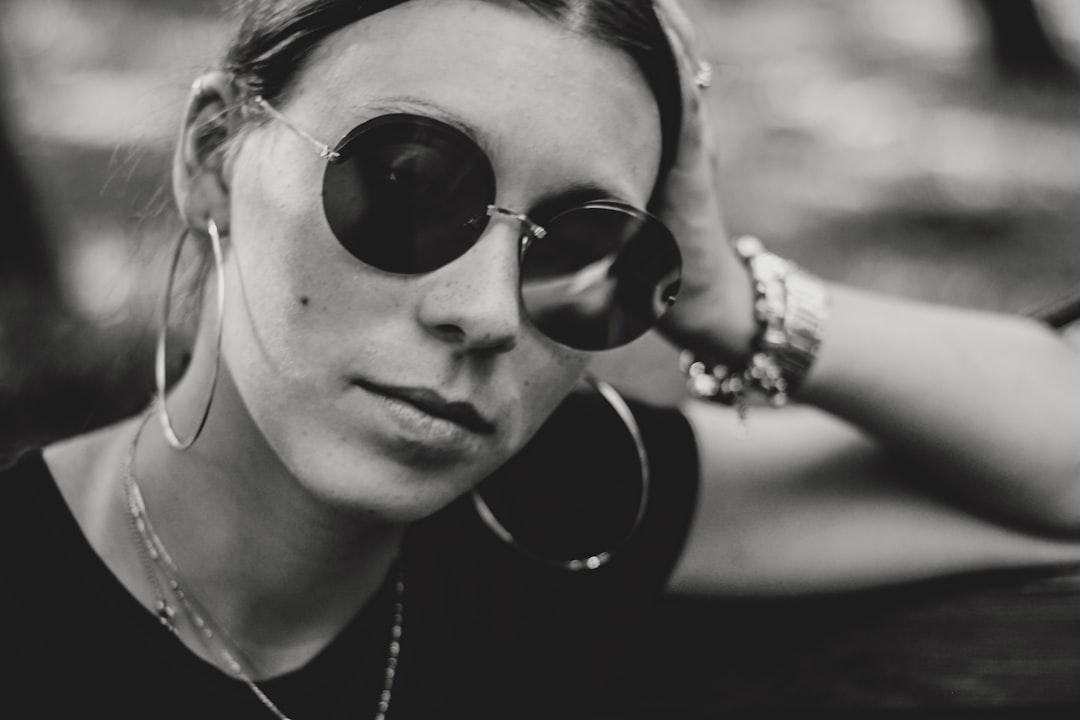 woman wearing hoop earrings and sunglasses