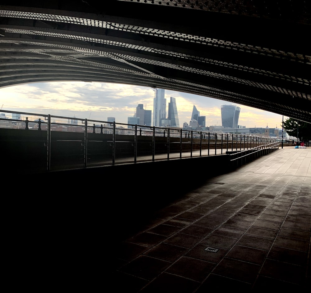 a person riding a skateboard under a bridge