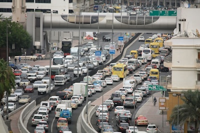A busy urban street filled with various modes of transportation, including cars and bicycles.