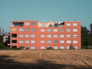 A modern prefab office cabin with bright orange accents in a Jeddah construction site.