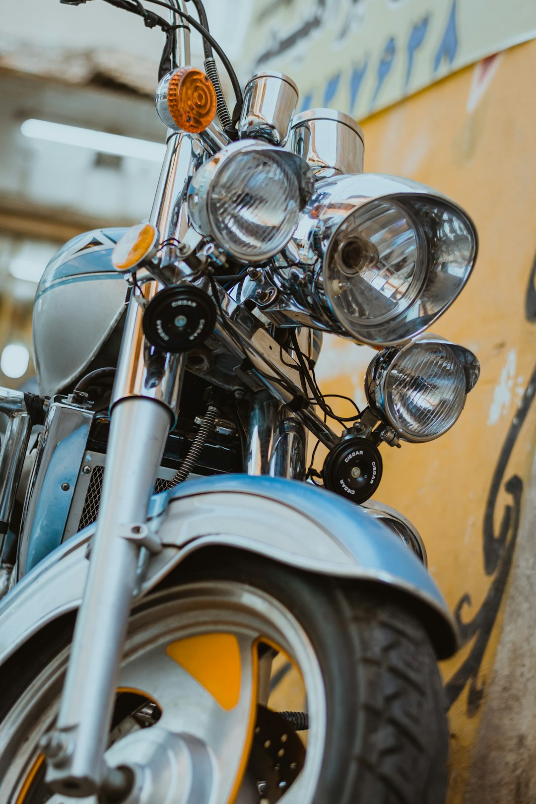 gray motorcycle near yellow wall