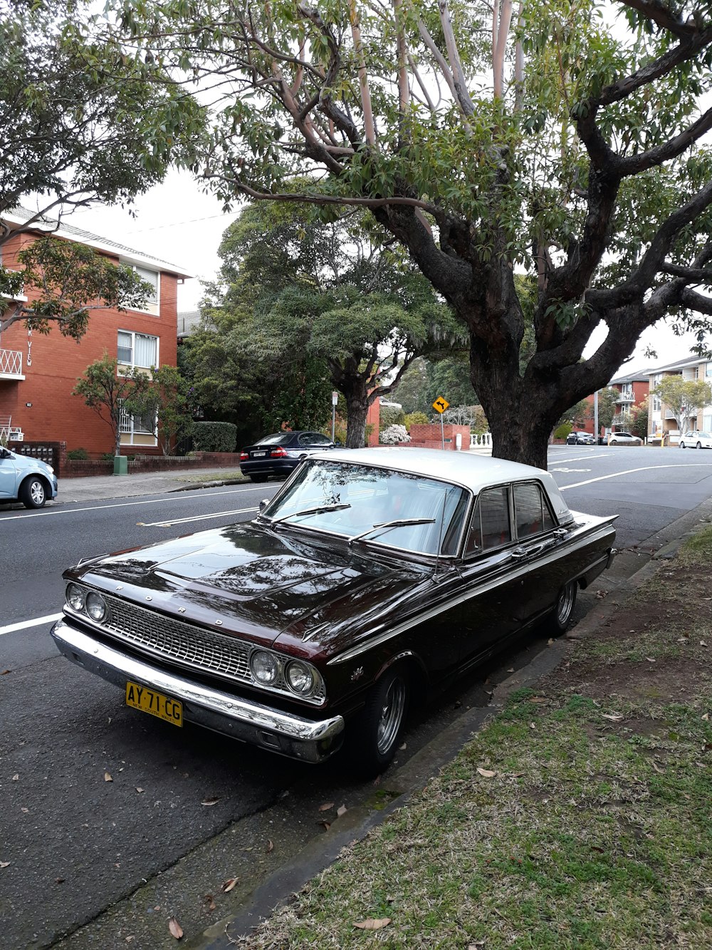 black sedan beside road