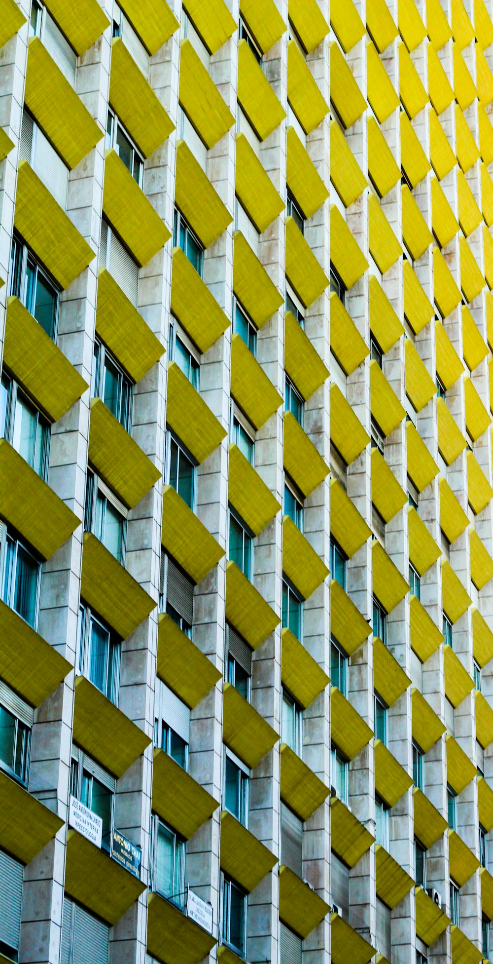 vista do arranha-céus de concreto cinza e amarelo durante o dia