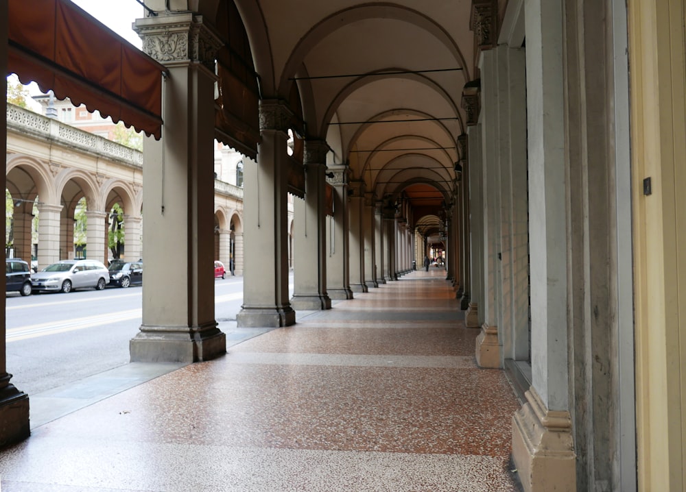 brown tiled hallway beside road during daytime