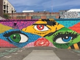 A street mural featuring an eye-catching advertisement painted on a brick wall.