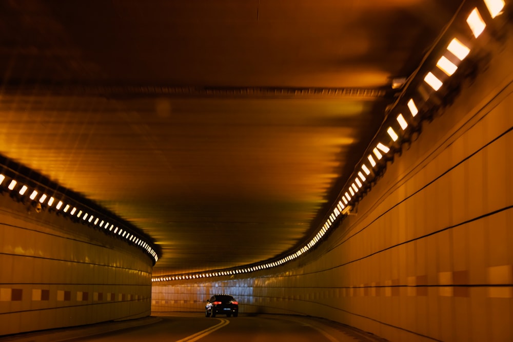 black vehicle running on the tunnel