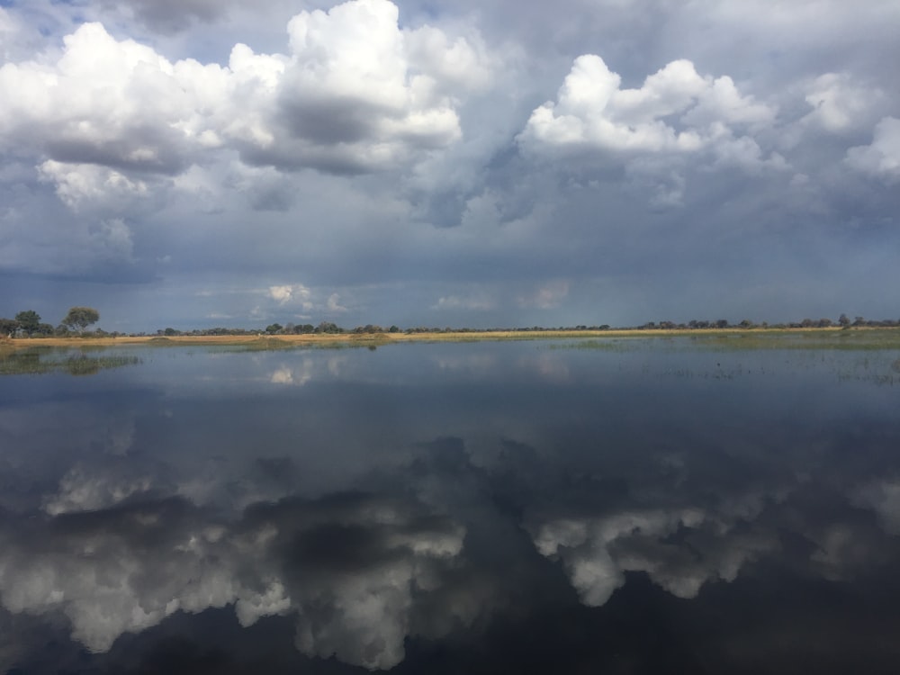 a large body of water surrounded by clouds