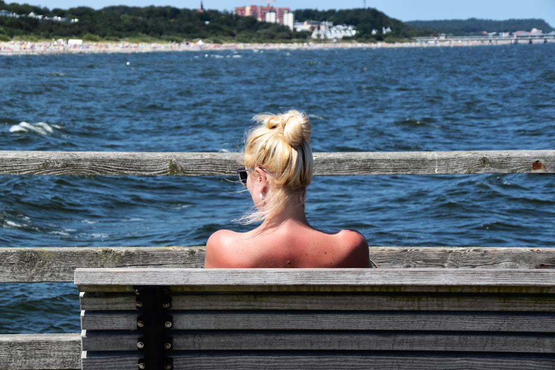 woman sitting on bench during daytime