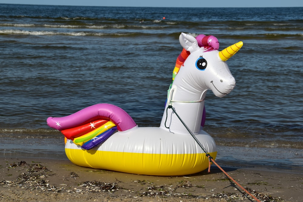 yellow and white inflatable floating unicorn