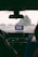 A view from inside a car, looking out through the windshield on a rainy day. A GPS device is mounted on the dashboard, displaying a map. Water droplets are visible on the glass, and there are two people in the front seats, one driver and one passenger.