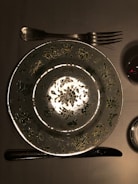 A creative logo design featuring a fork and plate on a rustic background