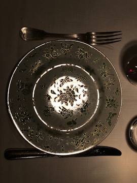 Logo design featuring a stylized fork and plate with elegant typography