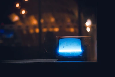 A sleek LED television glowing softly in a cozy living room setting