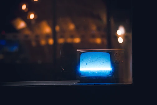 A restored photo displayed on a modern screen, glowing softly in a cozy room.