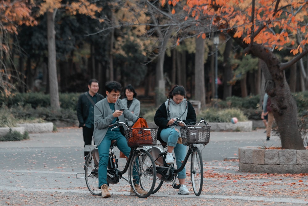 two person riding on bicycle during daytime