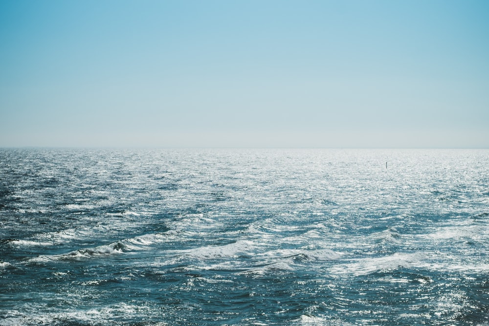 body of water under blue sky at daytime