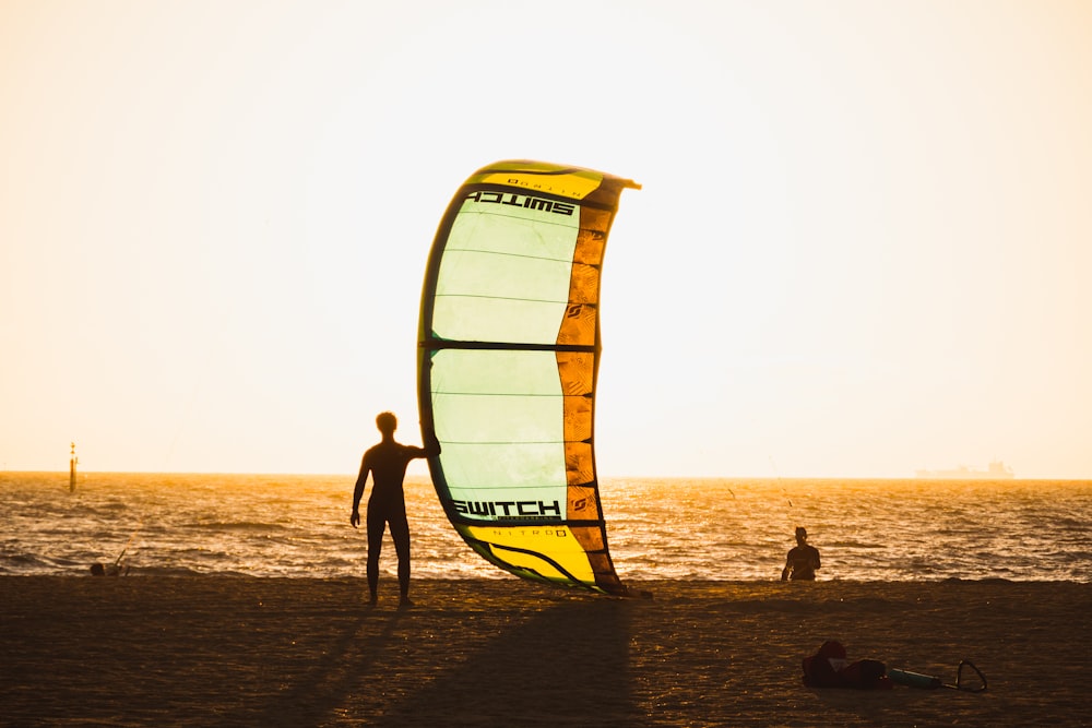 man holding sailboard