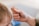 A close-up image of an adult hand gently holding a child's hand, conveying a sense of care and protection.