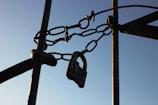 A close-up of a sturdy lock securing a storage unit door under clear blue skies.