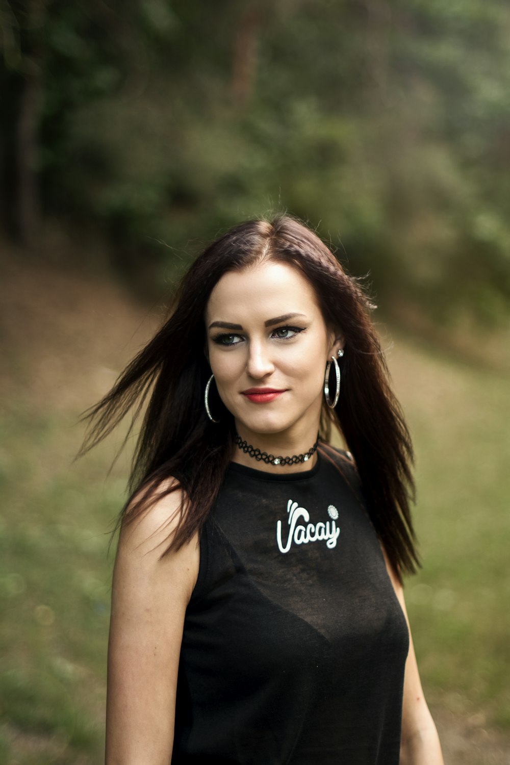 selective focus photo of woman wearing black and white tank top