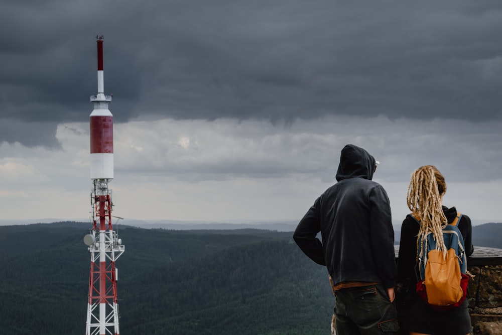 man and woman standing near tower