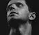 a black and white photo of a man looking up