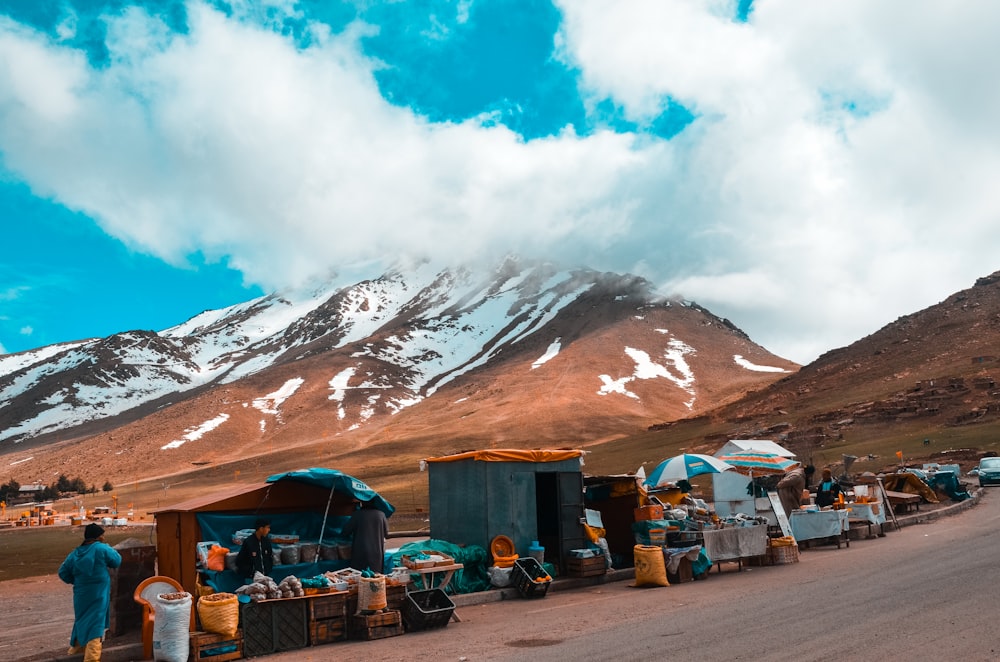 landscape photography of vendors on a mountain slope