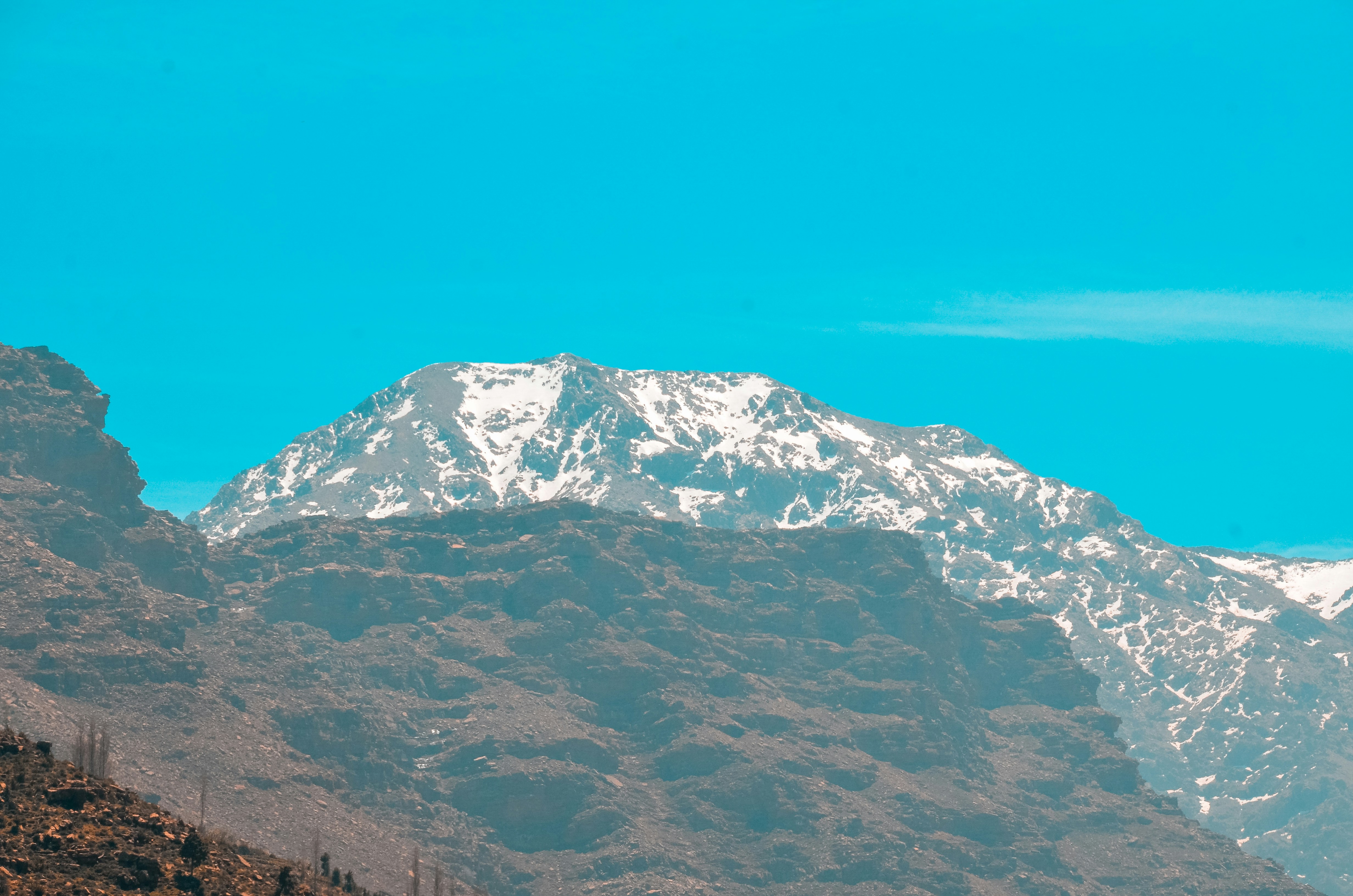 a view of a mountain range with snow on the top