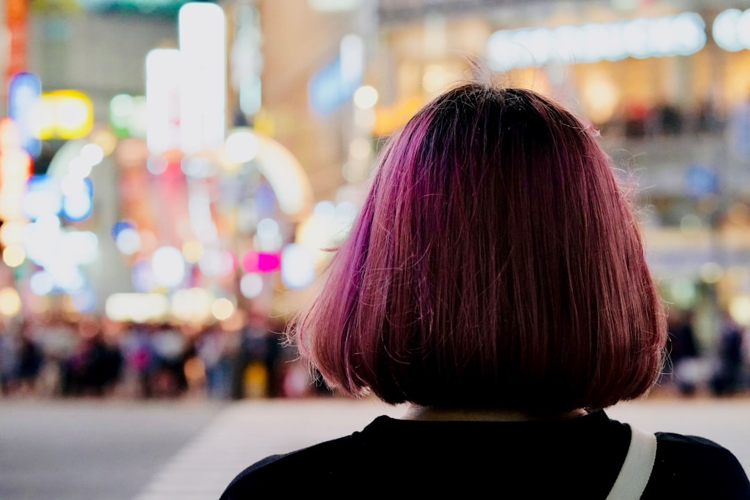 Woman with pink hair, from behind. Shibuya Crossing, Tokyo, Japan.