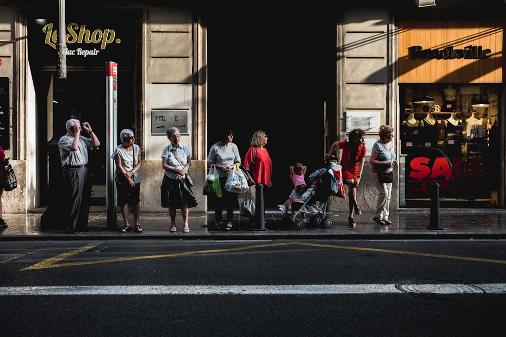 a group of people waiting at a bus stop