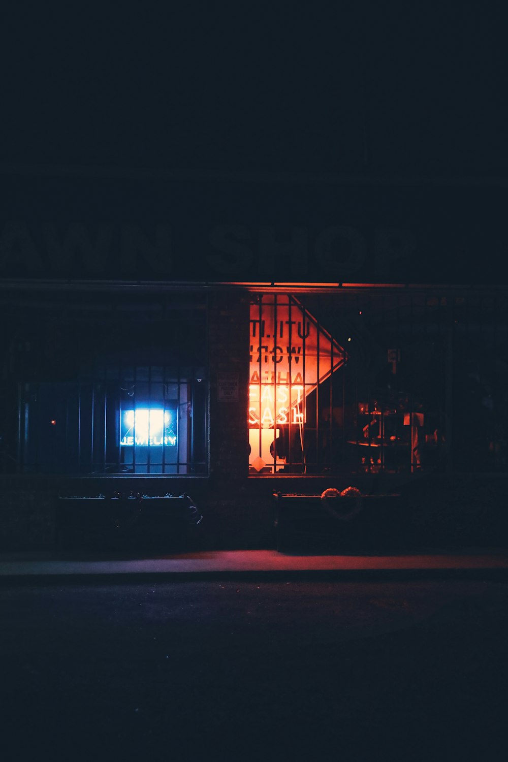 a truck parked in front of a building at night