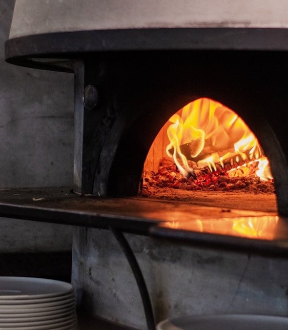 a pizza oven with a pizza inside of it