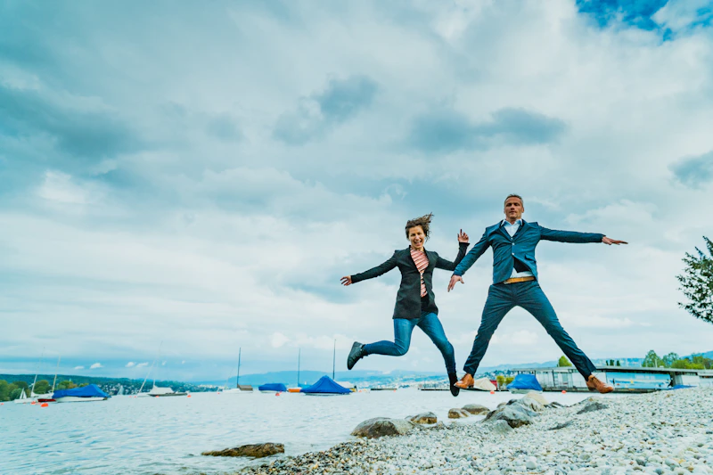 joyful couple jumping outdoors