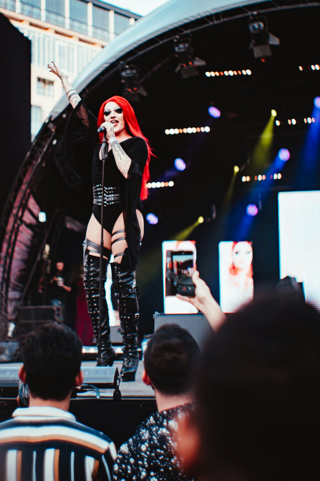 red haired woman performing on stage during daytime
