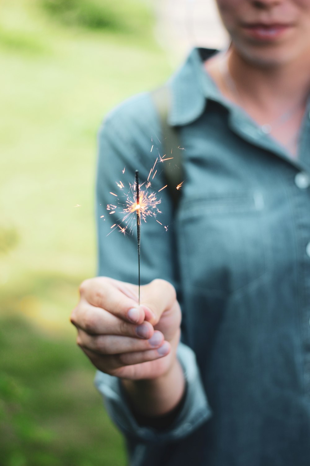 woman holding sparkling stick